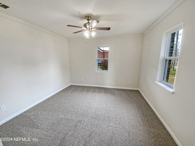 carpeted empty room featuring ceiling fan and crown molding