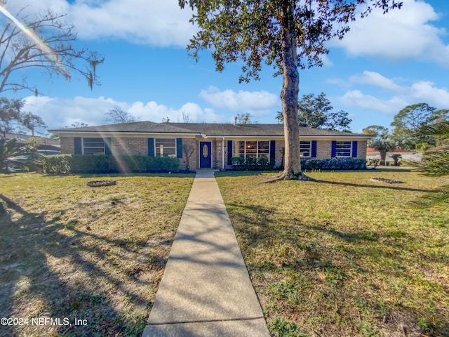 ranch-style home with a front lawn