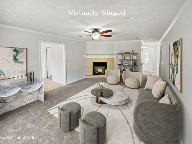 living room featuring light carpet, ceiling fan, and crown molding