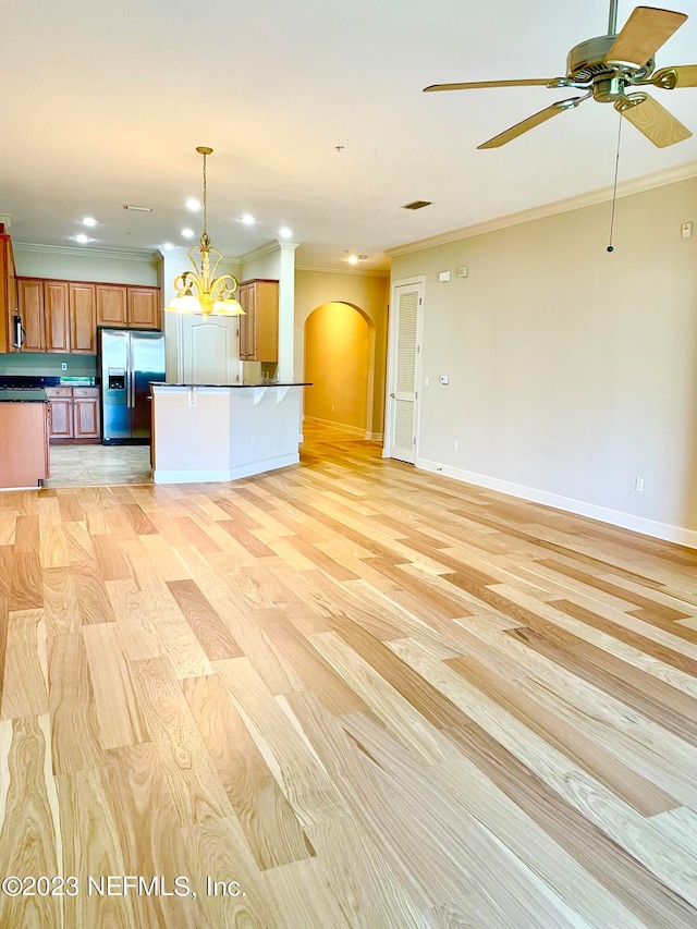 unfurnished living room featuring ornamental molding, light hardwood / wood-style flooring, and ceiling fan with notable chandelier