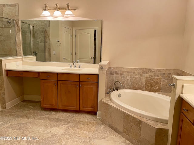 bathroom featuring tile floors, independent shower and bath, and vanity