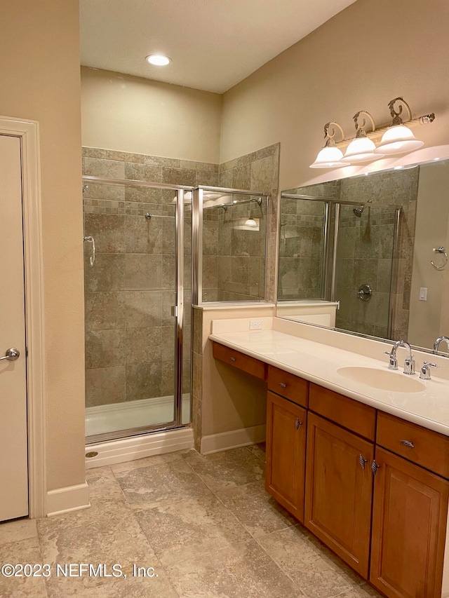 bathroom with tile flooring, an enclosed shower, and vanity