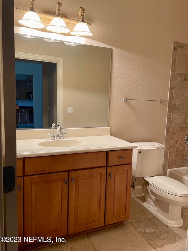 full bathroom with tiled shower / bath combo, tile flooring, toilet, and large vanity