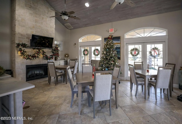 dining space featuring tile flooring, french doors, wooden ceiling, high vaulted ceiling, and ceiling fan