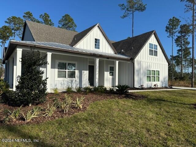 modern inspired farmhouse featuring a front lawn