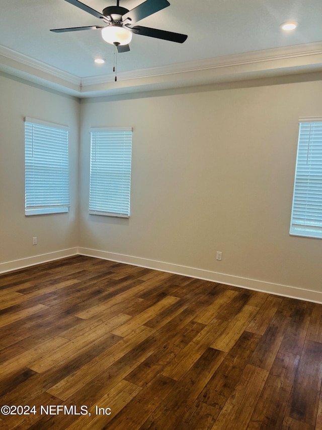 spare room featuring dark hardwood / wood-style floors, ceiling fan, and ornamental molding