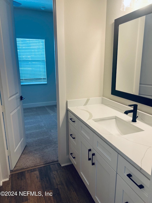 bathroom with vanity and hardwood / wood-style flooring