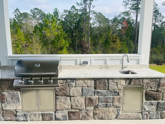 view of patio with an outdoor kitchen, sink, and a grill