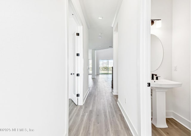 corridor with light wood-type flooring