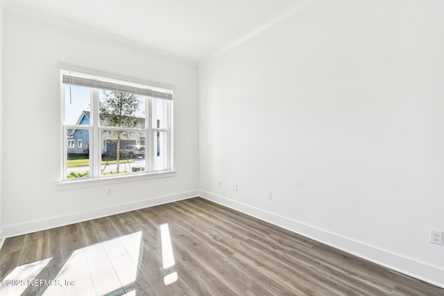 unfurnished room featuring ornamental molding and hardwood / wood-style floors