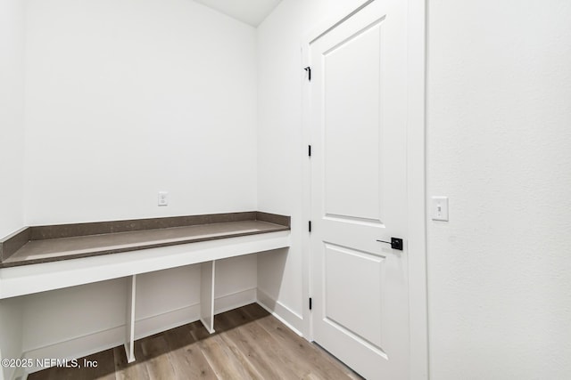 mudroom with light hardwood / wood-style floors