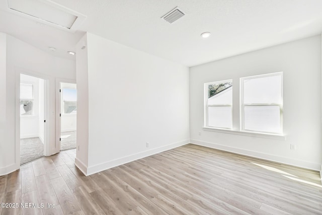 unfurnished room with light wood-type flooring