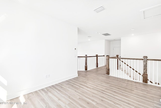 unfurnished room with light wood-type flooring