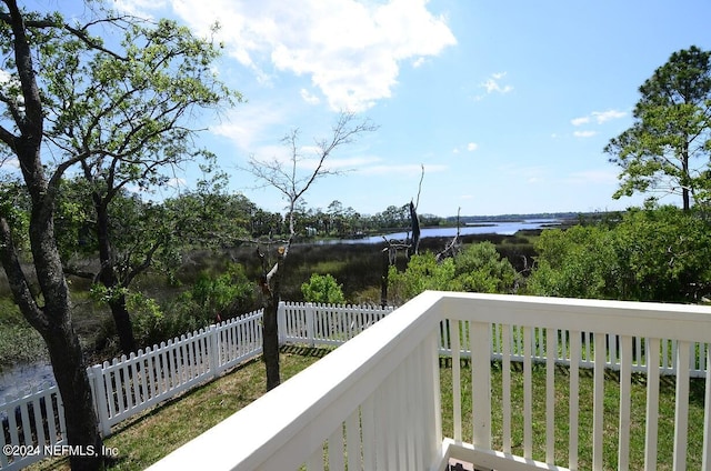 wooden terrace featuring a water view