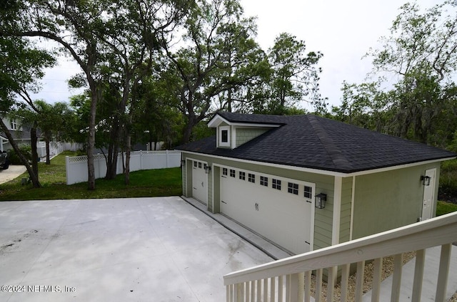 garage featuring a lawn