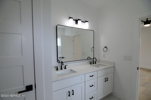 bathroom with hardwood / wood-style floors, vanity, and ceiling fan