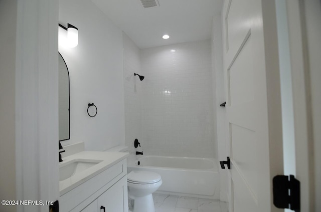 full bathroom with vanity, toilet, and tiled shower / bath combo