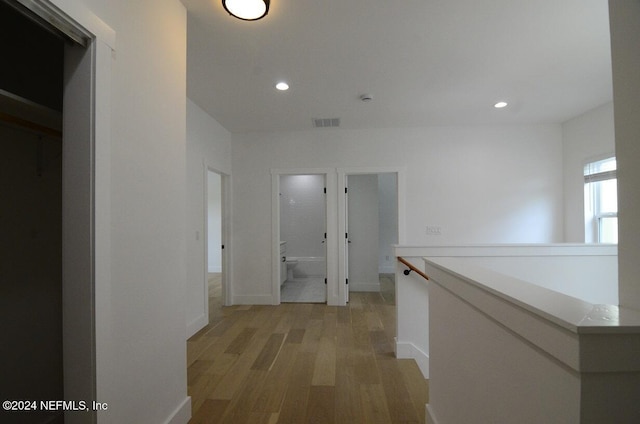 hallway with light hardwood / wood-style flooring