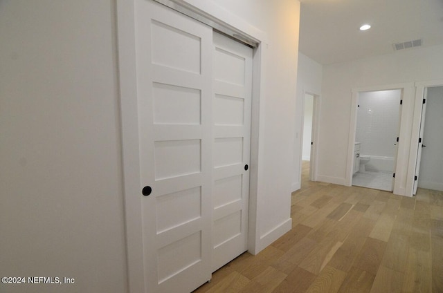 corridor with light hardwood / wood-style flooring