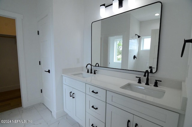 bathroom with a shower and vanity