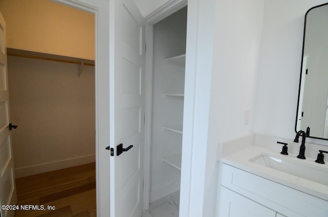 bathroom with vanity and hardwood / wood-style flooring