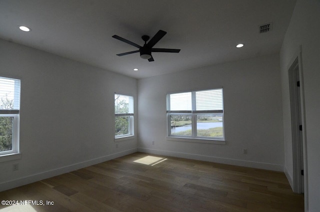 spare room featuring dark hardwood / wood-style floors and ceiling fan