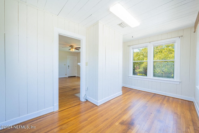 empty room with hardwood / wood-style floors and ceiling fan