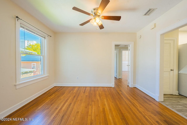 unfurnished room with ceiling fan and light wood-type flooring