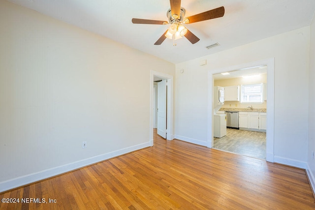 unfurnished bedroom with ensuite bath, sink, ceiling fan, and light wood-type flooring