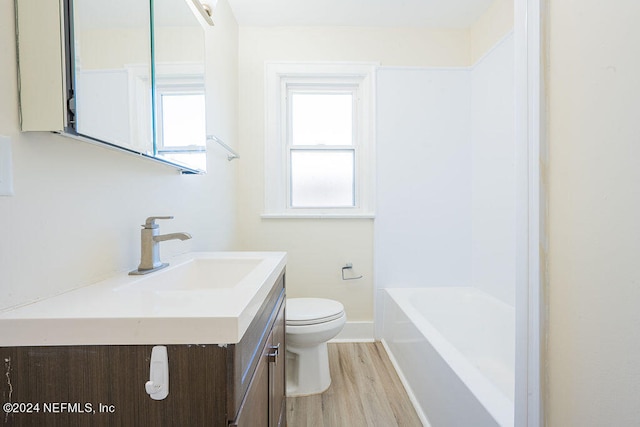 full bathroom featuring shower / bath combination, hardwood / wood-style floors, oversized vanity, and toilet