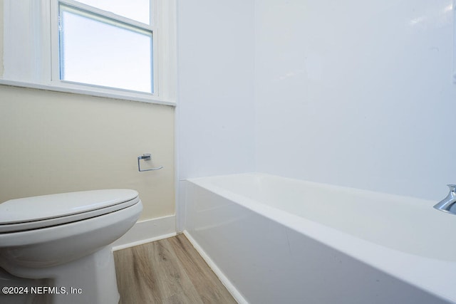 bathroom featuring toilet and wood-type flooring