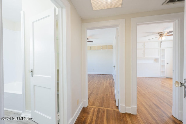 hall with wood-type flooring