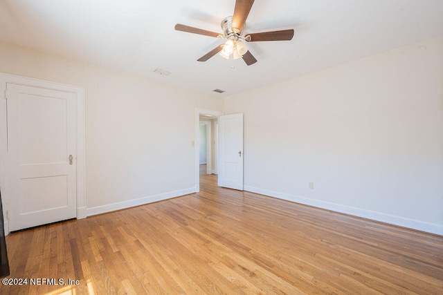 empty room featuring ceiling fan and light hardwood / wood-style flooring