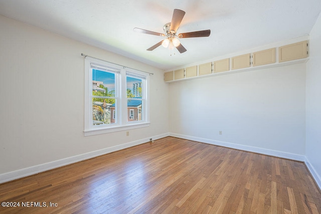 spare room featuring ceiling fan and hardwood / wood-style flooring