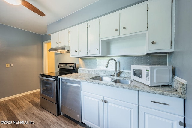 kitchen with white cabinets, stainless steel dishwasher, electric stove, and backsplash