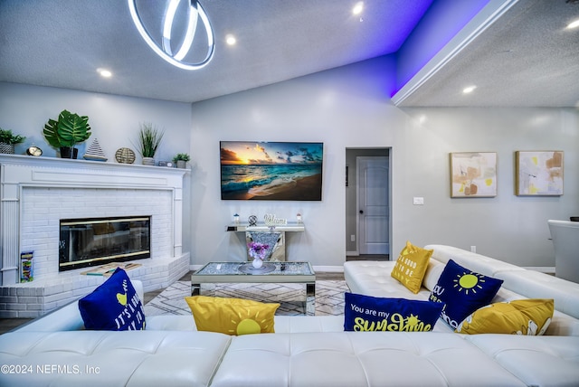 living room featuring lofted ceiling, a textured ceiling, and a fireplace