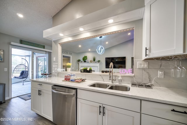 kitchen with light stone countertops, tasteful backsplash, light hardwood / wood-style flooring, lofted ceiling, and dishwasher