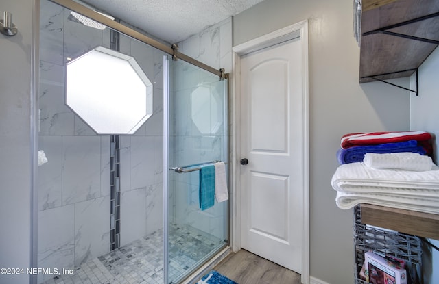 bathroom with walk in shower and hardwood / wood-style flooring