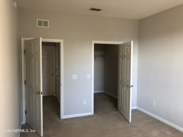 unfurnished bedroom featuring a closet and carpet