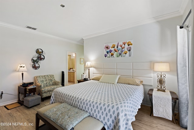 bedroom with ensuite bath, crown molding, and light wood-type flooring