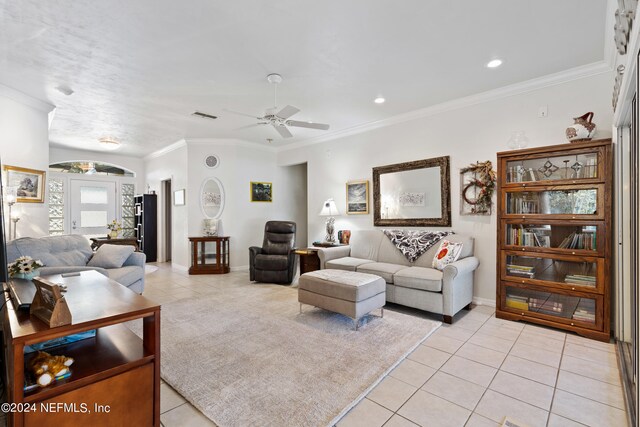 tiled living room featuring ornamental molding and ceiling fan