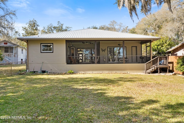 back of property with a lawn and ceiling fan