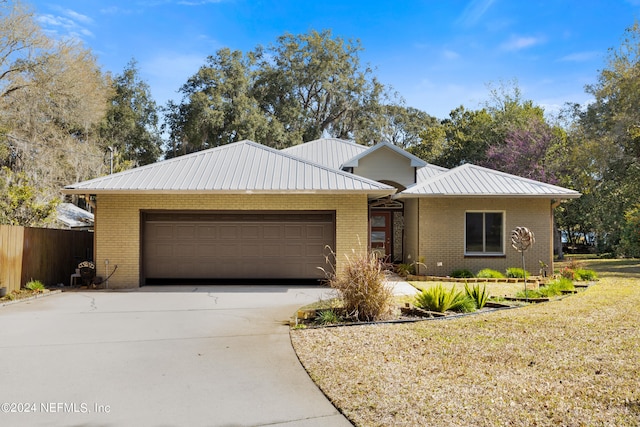 view of front of property with a front yard and a garage