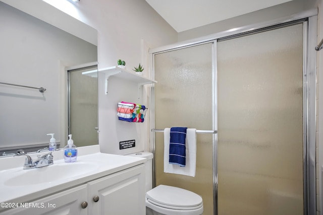 bathroom featuring an enclosed shower, toilet, and vanity with extensive cabinet space