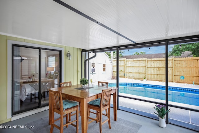 sunroom / solarium featuring a pool