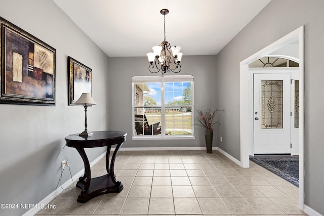 interior space featuring light tile flooring and an inviting chandelier