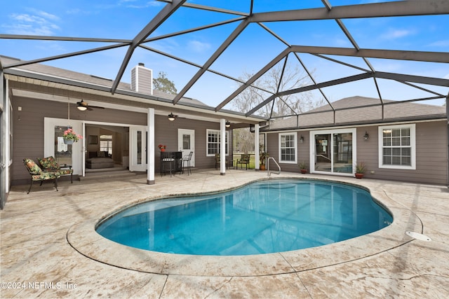 view of pool with a lanai, a patio area, and ceiling fan