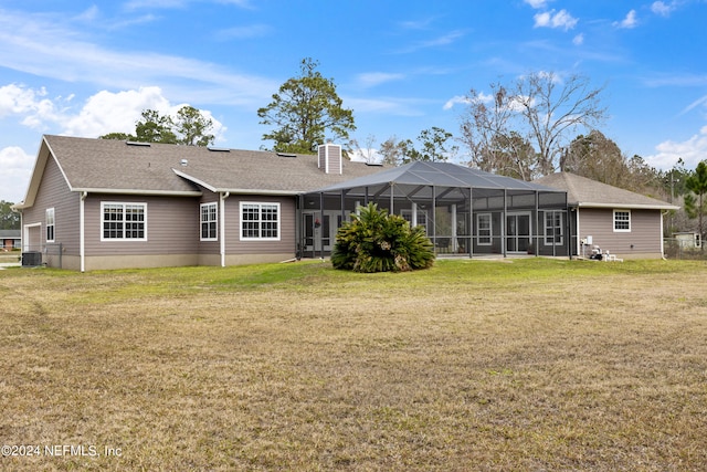 back of property featuring central AC unit, a lanai, and a lawn