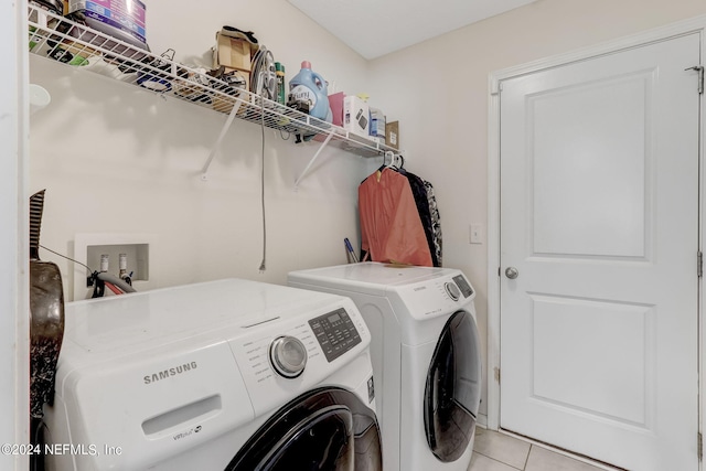 laundry area featuring hookup for a washing machine, separate washer and dryer, and light tile floors