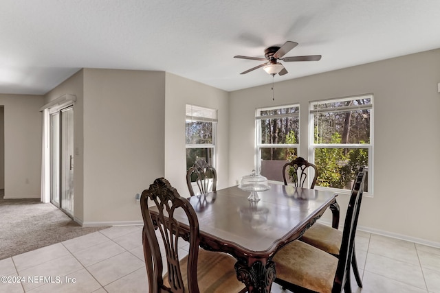 tiled dining area featuring ceiling fan and a wealth of natural light